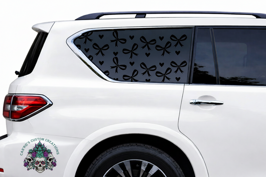 White car with matte black heart and bow decals on a white background